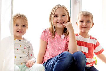 Image showing happy little kids having fun at window