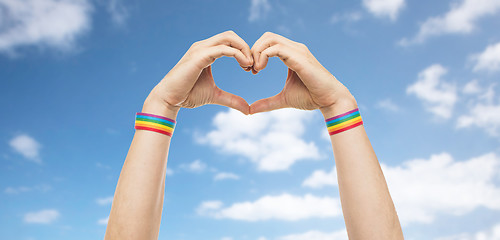 Image showing male hands with gay pride wristbands showing heart