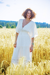 Image showing beautiful woman in white dress in a field outdoors on a summer d