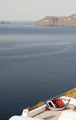 Image showing old fishing boat over harbor oia ia santorini greek island