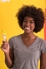 Image showing black woman painting wall