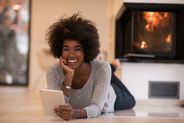 Image showing black women using tablet computer on the floor