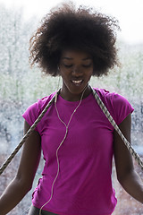 Image showing portrait of young afro american woman in gym while listening mus