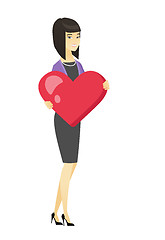 Image showing Asian business woman holding a big red heart.