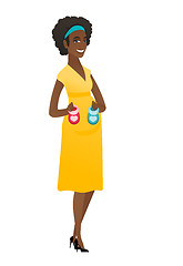 Image showing African pregnant woman holding baby booties.