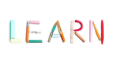 Image showing The word learn created from office stationery.