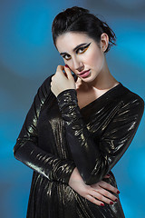 Image showing Fashion young woman in black stilish dress. Glamour sexy model in fashion pose, stylish make-up, fashion heels.