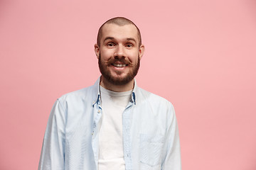 Image showing The happy business man standing and smiling against pink background.