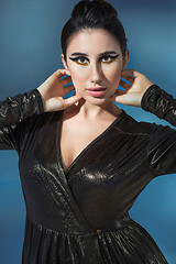 Image showing Fashion young woman in black stilish dress. Glamour sexy model in fashion pose, stylish make-up, fashion heels.