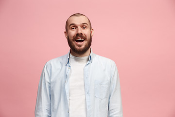 Image showing The happy business man standing and smiling against pink background.