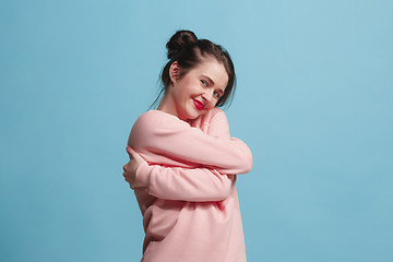 Image showing The happy business woman standing and smiling against pastel background.