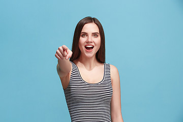 Image showing The happy woman point you and want you, half length closeup portrait on blue background.