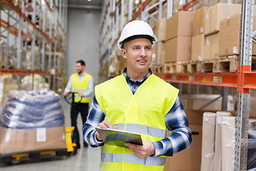 Image showing warehouse worker with clipboard in safety vest