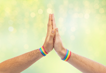 Image showing hands with gay pride wristbands make high five