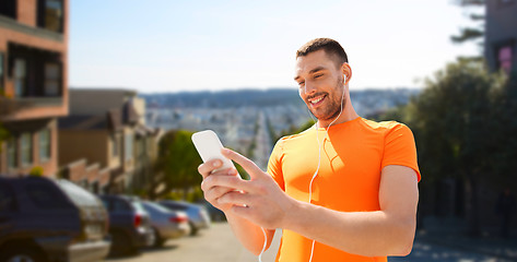 Image showing man with smartphone and earphones in san francisco