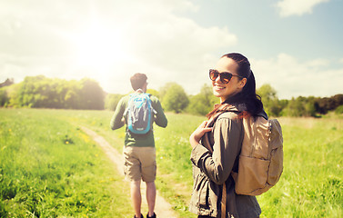 Image showing happy couple with backpacks hiking outdoors