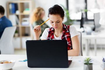 Image showing creative woman with laptop computer at office