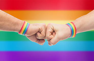 Image showing hands with gay pride wristbands make fist bump