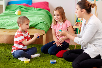 Image showing kids and mother with modelling clay or slimes