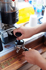 Image showing Barista pouring milk in cup