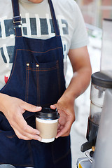 Image showing Barista pouring milk in cup