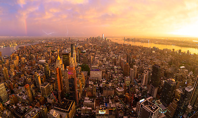 Image showing New York City skyline with Manhattan skyscrapers at dramatic stormy sunset, USA.