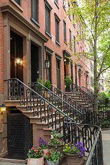 Image showing Row of old brownstone buildings along an empty sidewalk block in the Greenwich Village neighborhood of Manhattan, New York City NYC