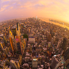 Image showing New York City skyline with Manhattan skyscrapers at dramatic stormy sunset, USA.