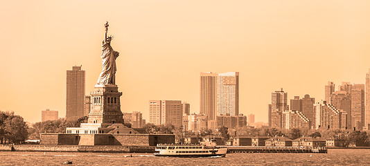 Image showing Statue of Liberty with Liberty State Park and Jersey City skyscrapers in background, USA