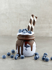 Image showing dessert of frozen banana, icecream and blueberries