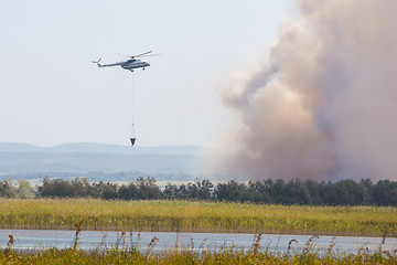 Image showing Fire extinguishing using a helicopter MI8