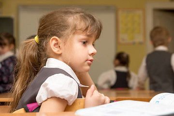 Image showing The girl is a first grader at the break in the school class