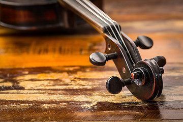 Image showing Old violin in vintage style on wood background