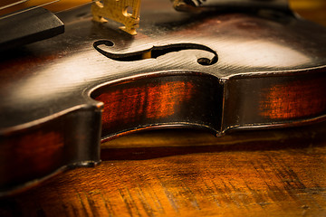 Image showing Old violin in vintage style on wood background