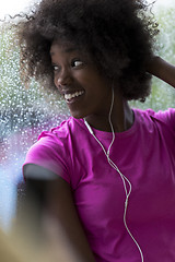 Image showing portrait of young afro american woman in gym while listening mus