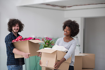 Image showing multiethnic couple moving into a new home