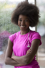 Image showing portrait of young afro american woman in gym while listening mus