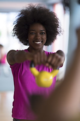 Image showing woman working out in a crossfit gym with dumbbells