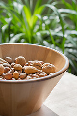 Image showing Nuts in wooden bowl