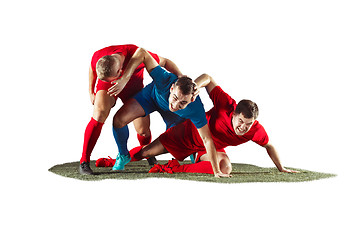 Image showing Football players tackling for the ball over white background