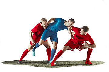 Image showing Football players tackling for the ball over white background