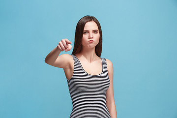 Image showing The overbearing woman point you and want you, half length closeup portrait on blue background.