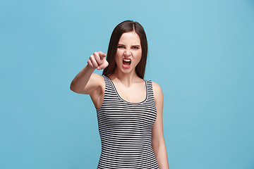 Image showing The overbearing woman point you and want you, half length closeup portrait on blue background.