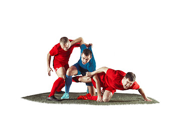 Image showing Football players tackling for the ball over white background