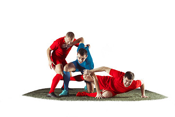 Image showing Football players tackling for the ball over white background