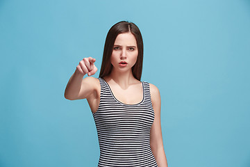 Image showing The overbearing woman point you and want you, half length closeup portrait on blue background.