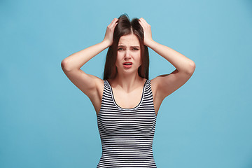 Image showing Woman having headache. Isolated over pastel background.