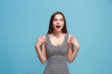 Image showing Beautiful woman looking suprised isolated on blue