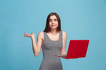 Image showing Businesswoman with laptop on blue studio