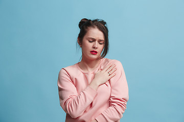 Image showing Young woman overwhelmed with a pain in the shoulder